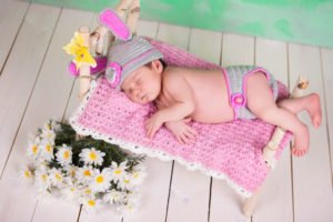 newborn-baby-girl-photo-props-in-a-knitted-hare-costume-sleeping